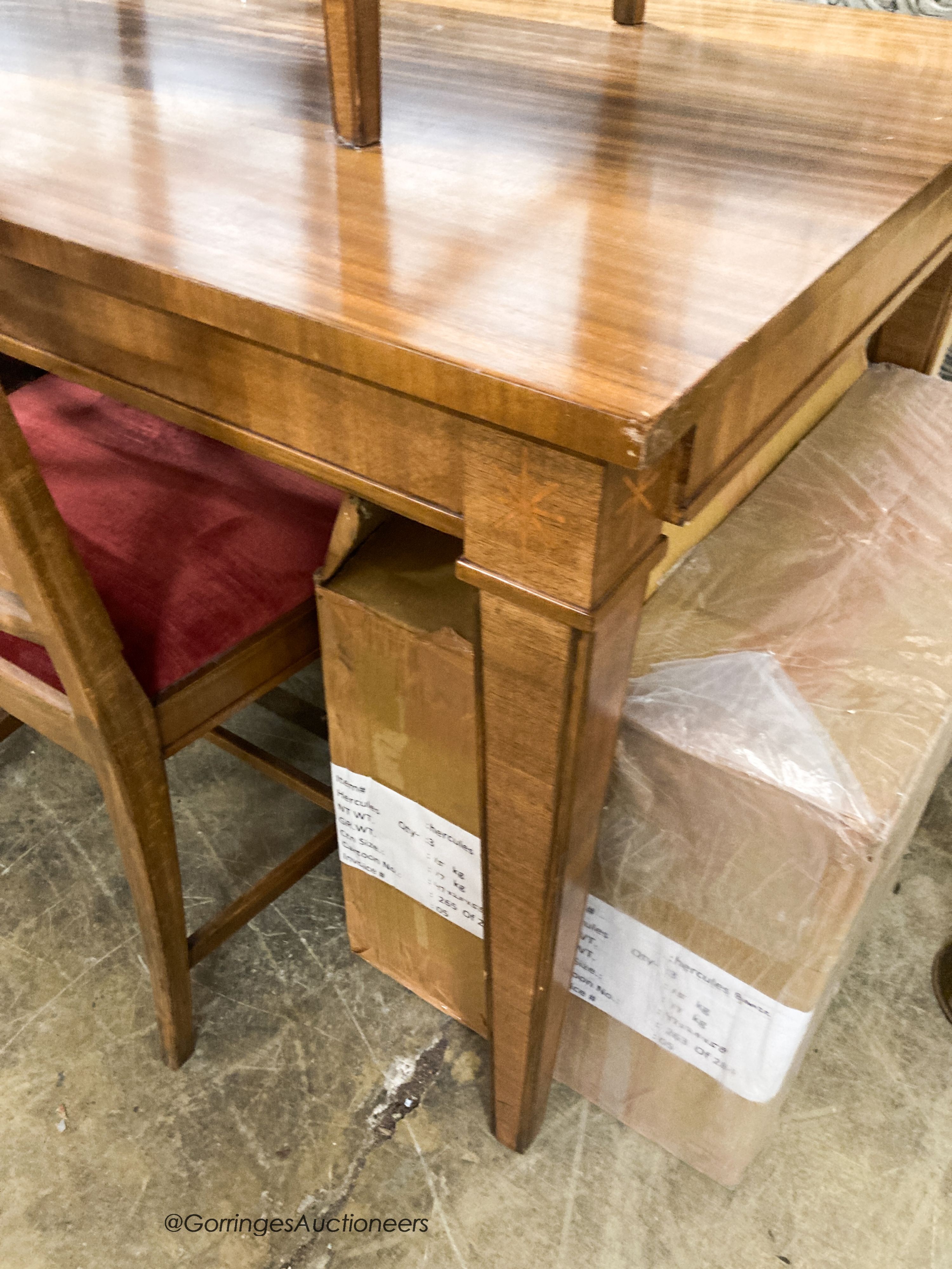 A Swedish walnut and beech dining suite comprising rectangular table. 200cm extended (two spare leaves) and four lattice back chairs with upholstered drop in seats